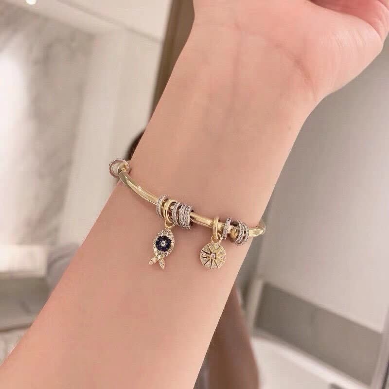 APM Monaco Gold Tone Bracelet with Fish and Star Charms